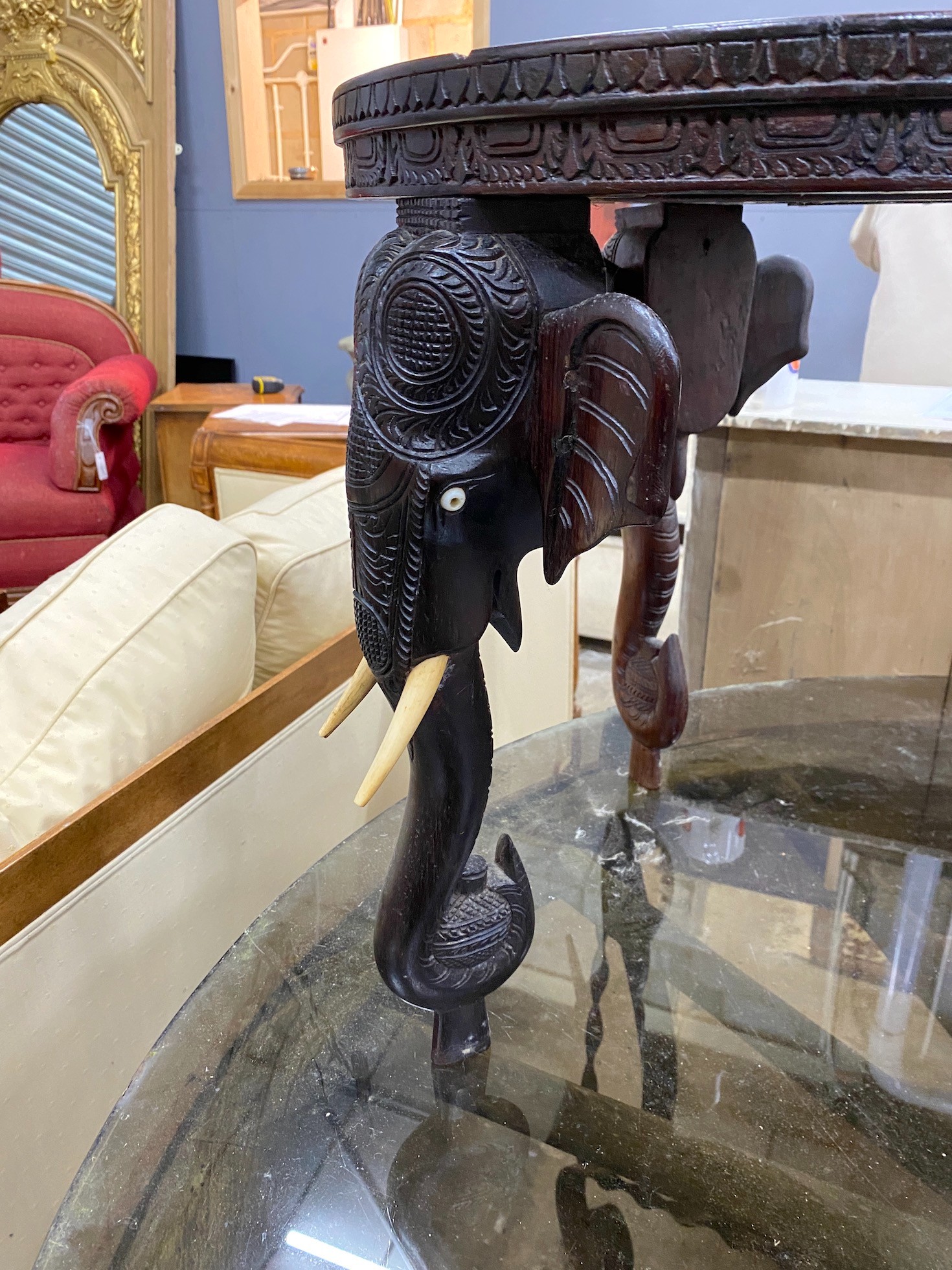 A pair of Indian circular carved hardwood elephant occasional tables, diameter 45cm, height 48cm